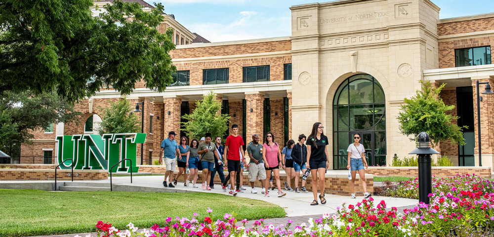 Visitors in front of the UNT Welcome Center