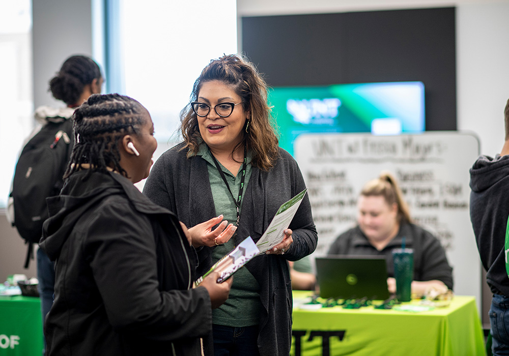 UNT admission counselor speaking to a prospective transfer student at an event at UNT Frisco.